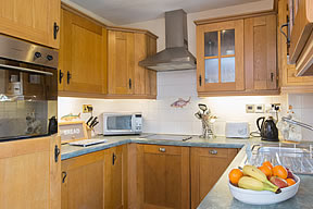 Well equipped kitchen with solid beech units and built in cooker
