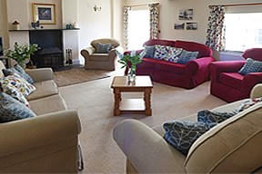 Spacious sitting room with woodburner